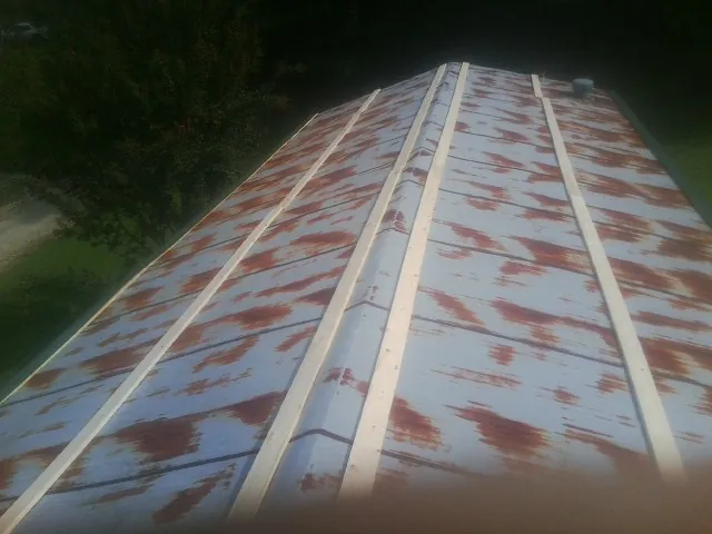 Rusted metal roof panels with new wood purlins before replacement — Storm Damage Roof Repair in Mackville by Roofing Brothers