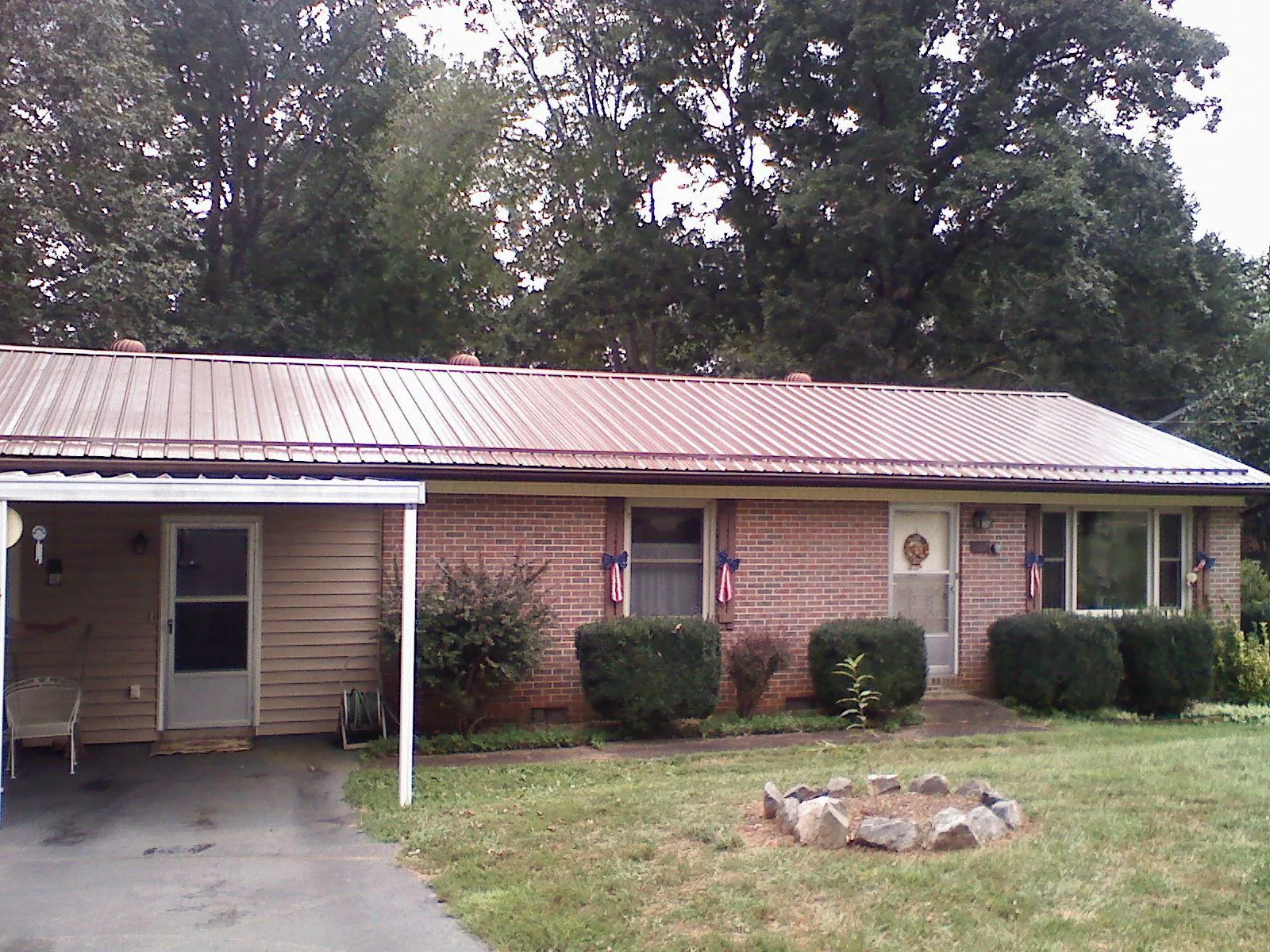 Bronze metal roof and carport on a brick ranch home — Roof Repair work by our crew in Mackville
